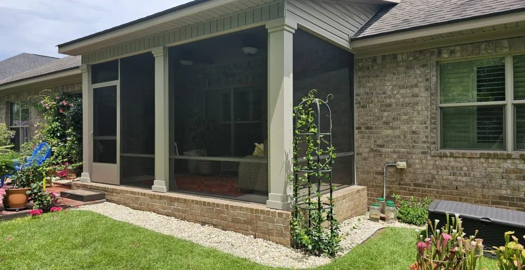 Screened porch enclosure on a brick home